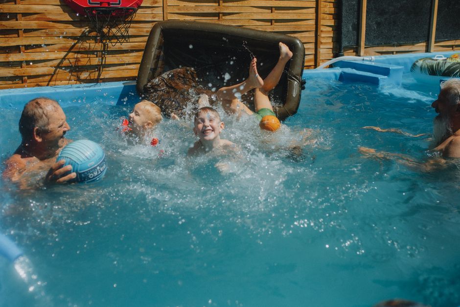 Gezin geniet van waterpret in opblaaszwembad.